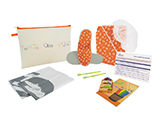 GÉNÉRALE DE SANTÉ CHILD OUTPATIENT KIT (FABRIC) | Personalised fabric case with cap, gown and printed child's slippers, toothbrushes with toothpaste, shoehorn, bags for patient's clothes and shoes, colouring book and pens and outpatient information card.